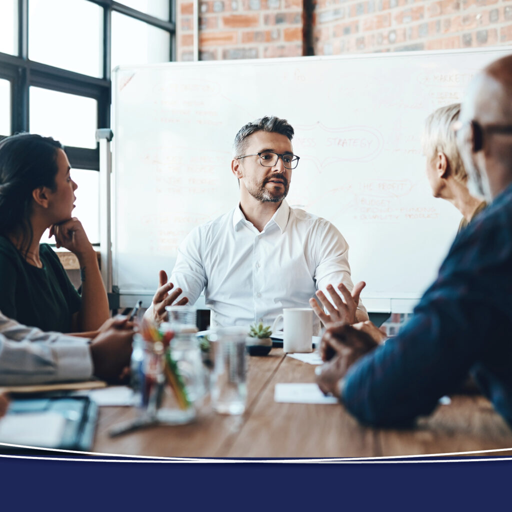 Financial professionals sitting at a table discussing